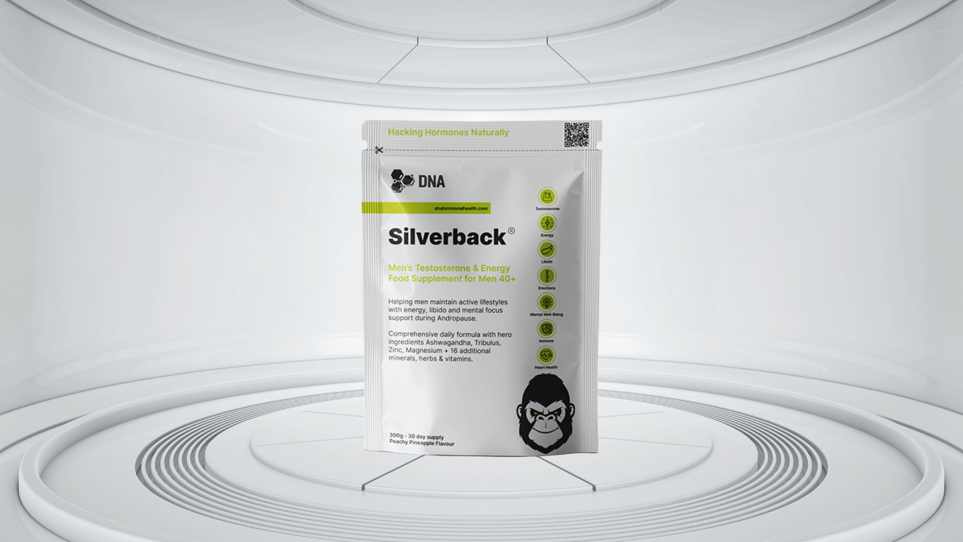 Front view of "Silverback" men's testosterone and energy food supplement by DNA, displayed in a futuristic white setting. The pouch highlights benefits for men 40+ including support for testosterone, energy, libido, erections, mental well-being, and heart health. Key ingredients listed include Ashwagandha, Tribulus, Zinc, and Magnesium, along with 16 additional herbs, vitamins, and minerals. Branding emphasises natural hormone support with a peachy pineapple flavour and a 30-day supply.