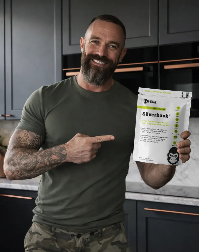 Smiling man holding Silverback natural testosterone support supplement for men over 40