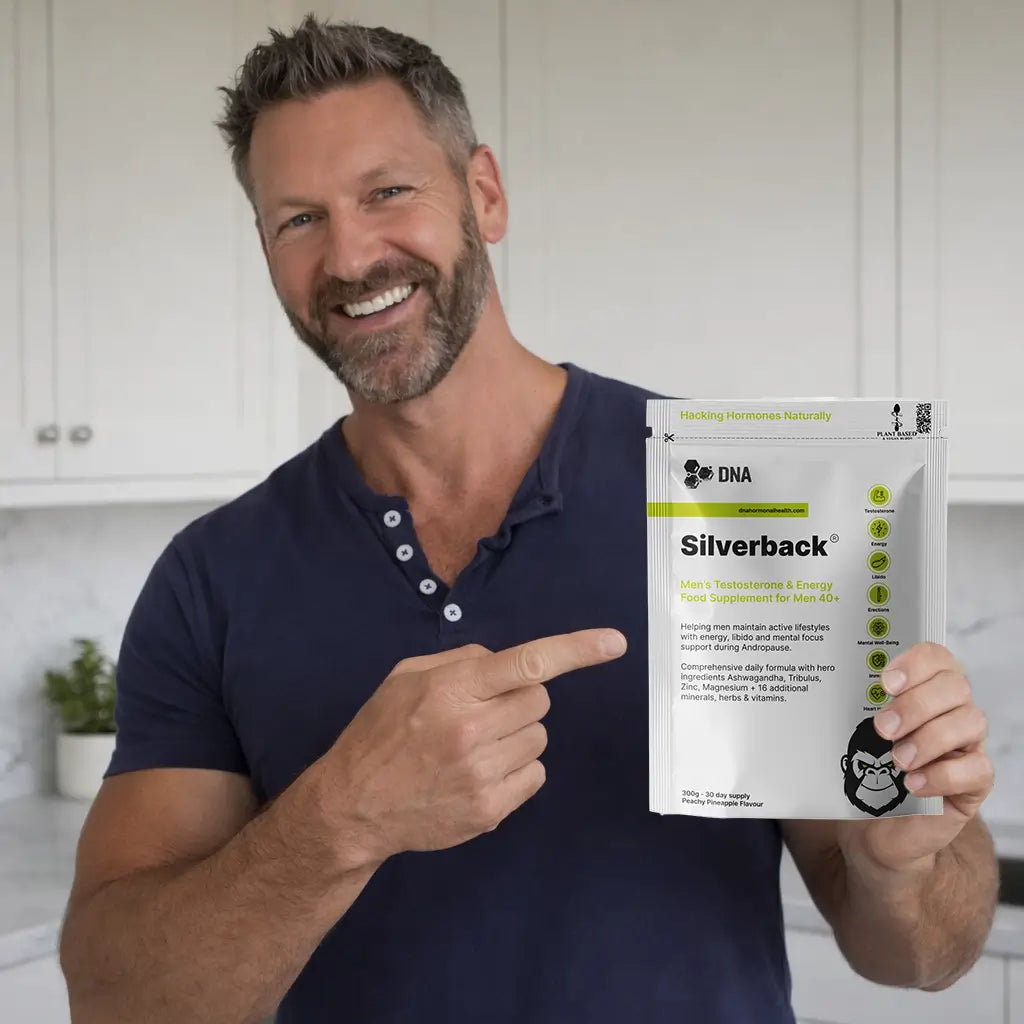 Smiling man holding Silverback natural testosterone support supplement for men over 40